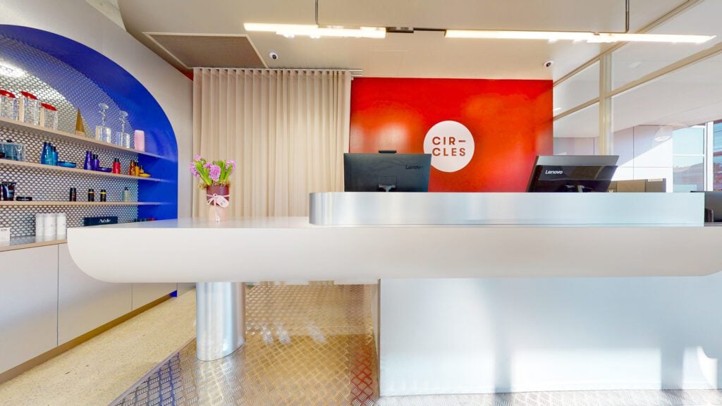 The blue arches and reception counter inside Circles of Hair Subiaco