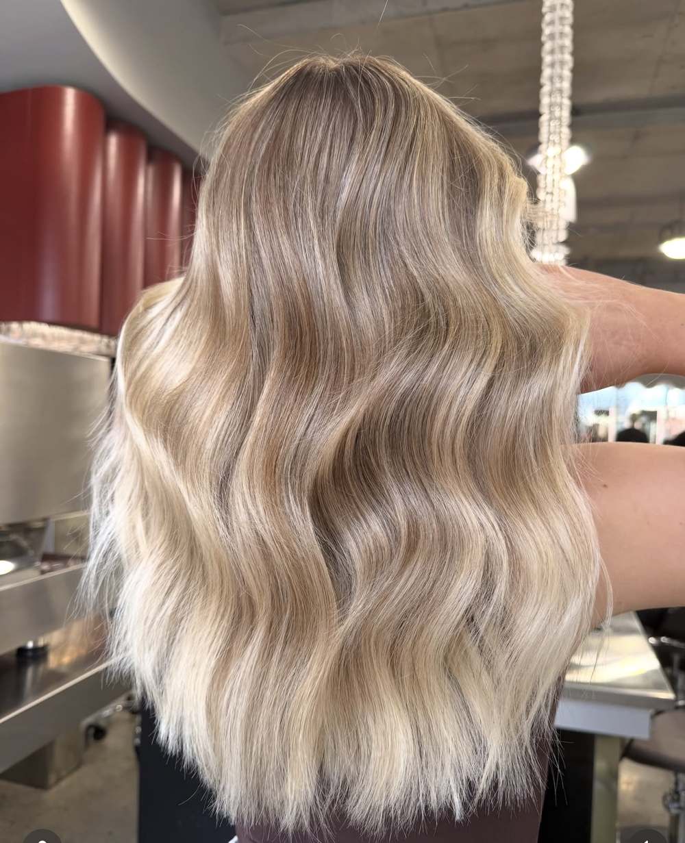 Hand-sewn weft hair extensions creating thick beachy blonde waves, Circles of Hair Perth
