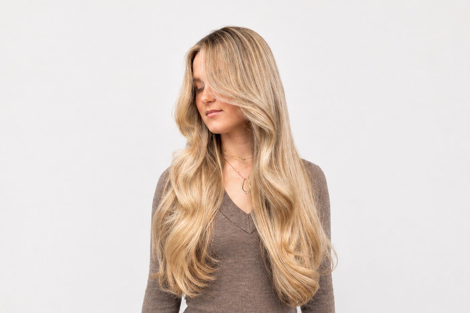 Three quarter head of foils brightening long blonde hair through the top, sides and back
