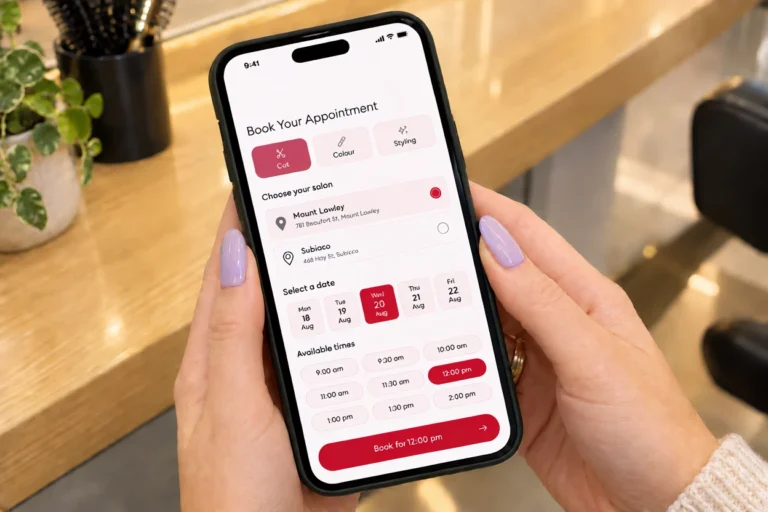 Hands holding a phone showing a Perth hair salon appointment booking screen